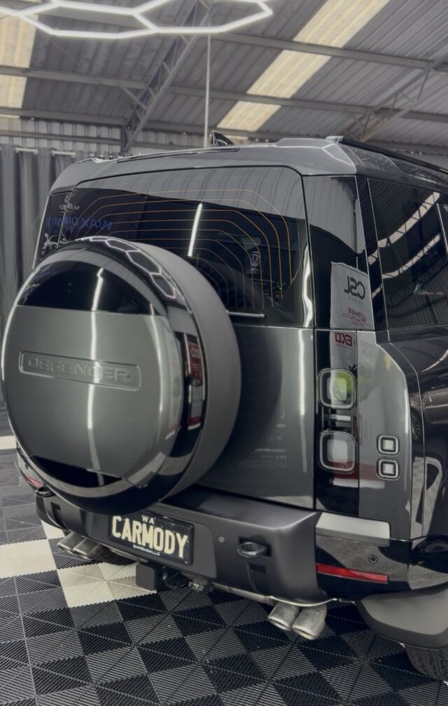 Rear view of a grey four-wheel drive wagon with a rear-mounted spare wheel, coated and finished in the workshop