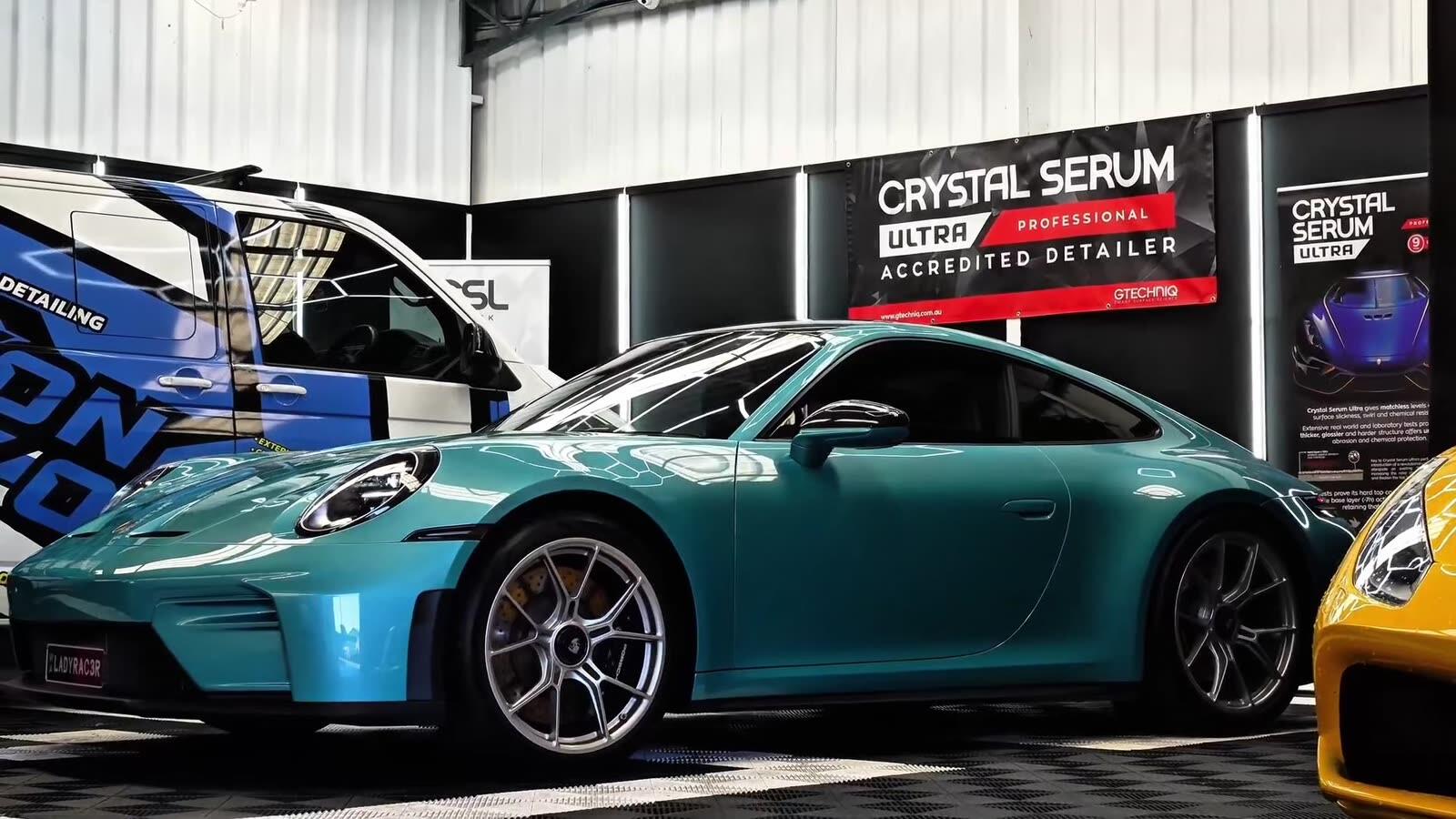A Porsche 911 GT3 in the Wax On Wax Off Detailing workshop in Rockingham, its coated paintwork reflecting the workshop lighting