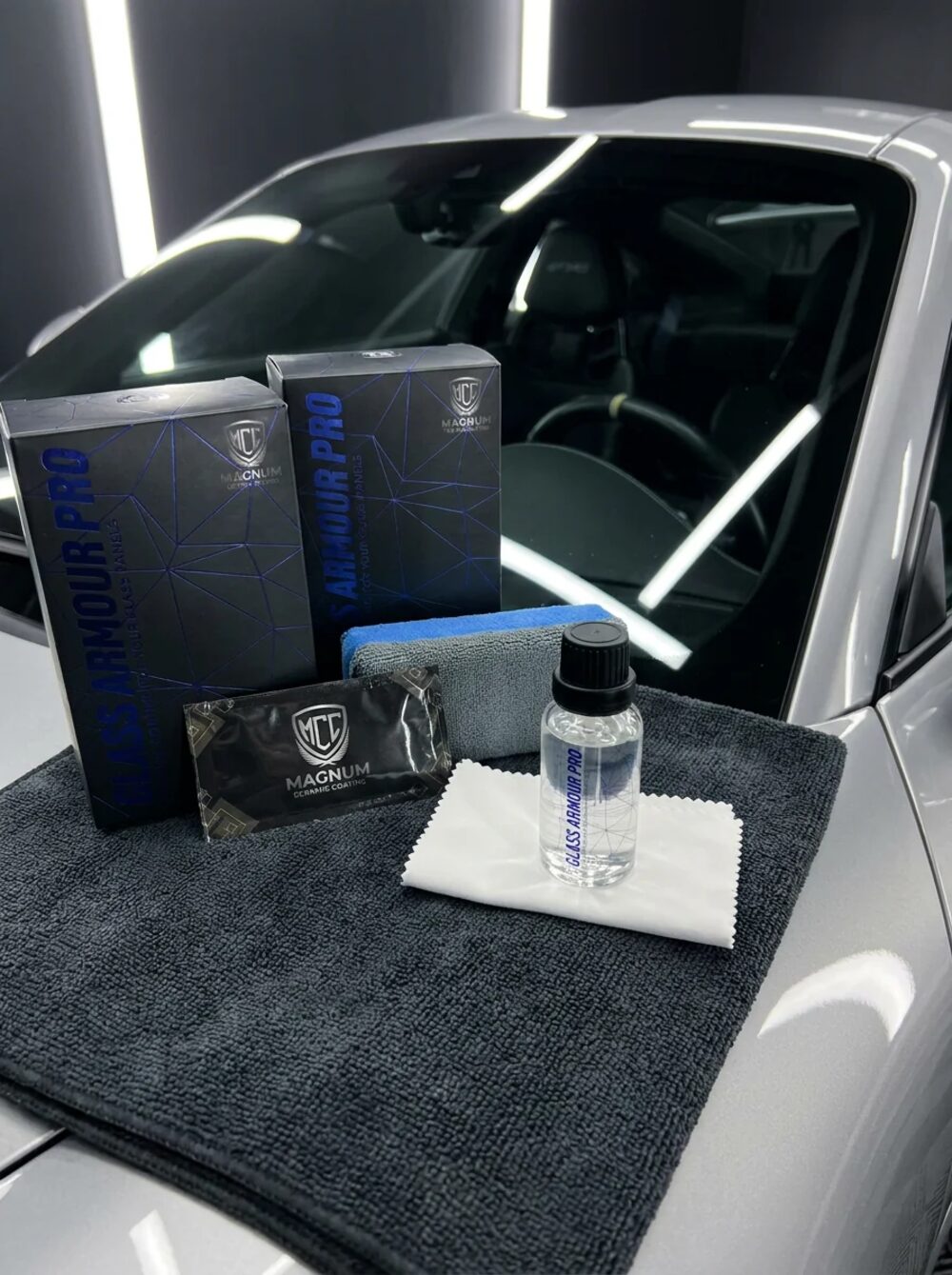 Magnum glass coating kit laid out on a vehicle before the exterior glass is treated