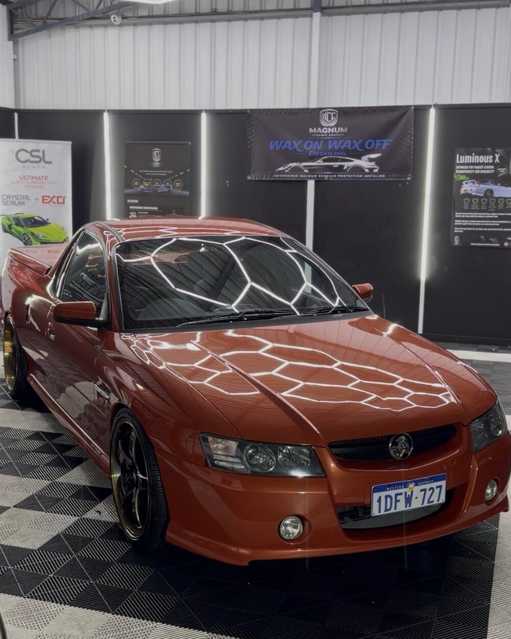 The Wax On Wax Off Detailing workshop in Rockingham, a coated vehicle under the hexagon inspection lighting